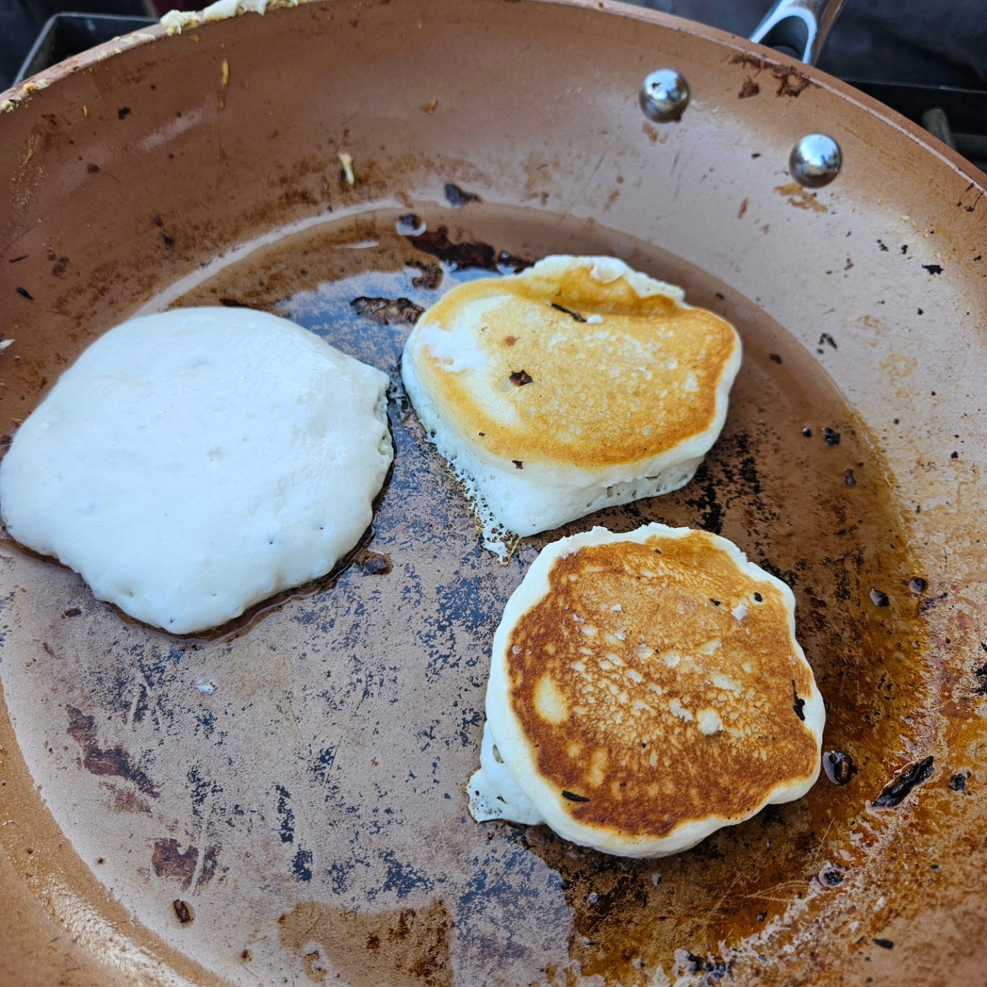 Pancakes cooking on the griddle at a Weber Fridge community breakfast